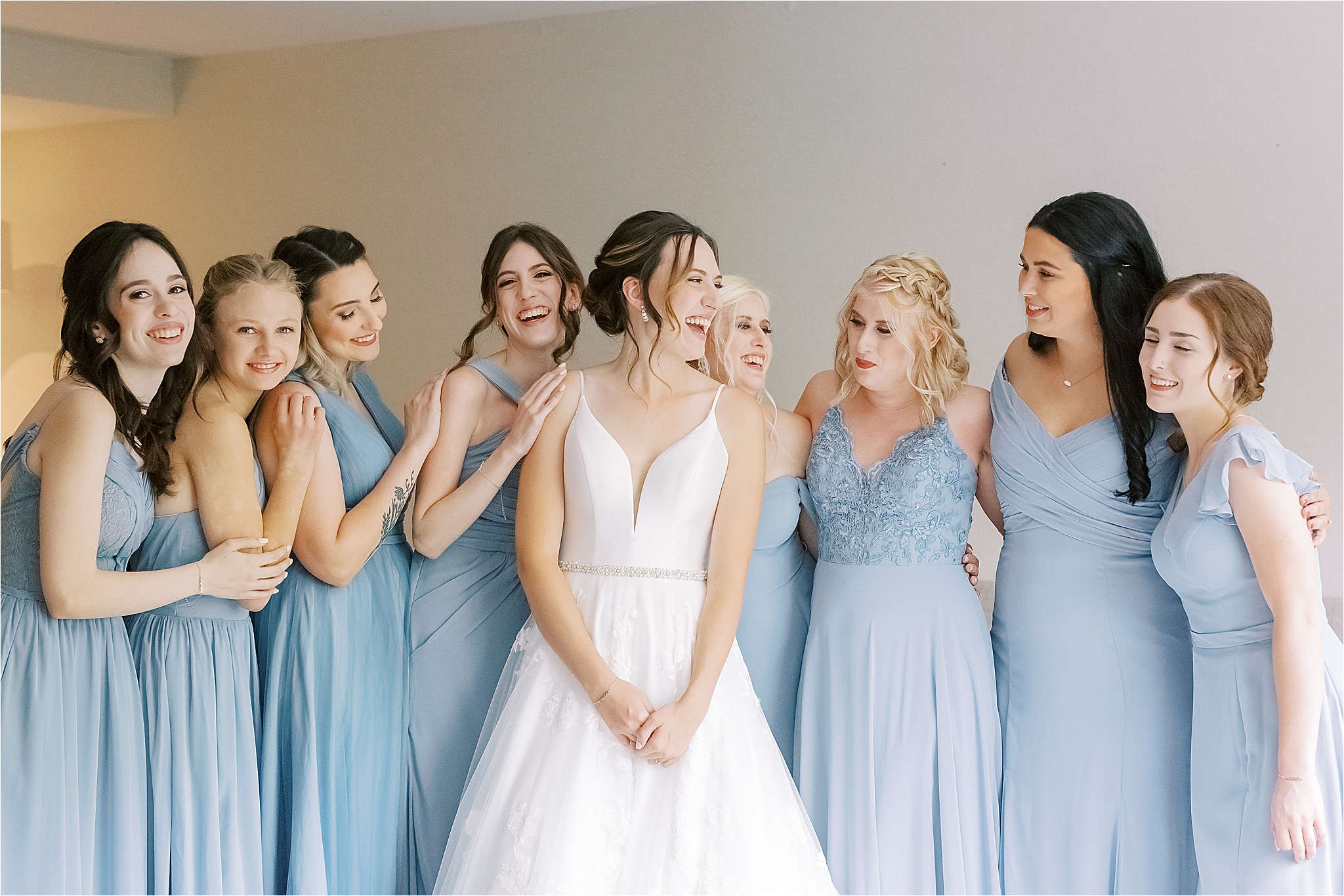 bride surrounded by bridesmaids while getting ready for Medina Wedding