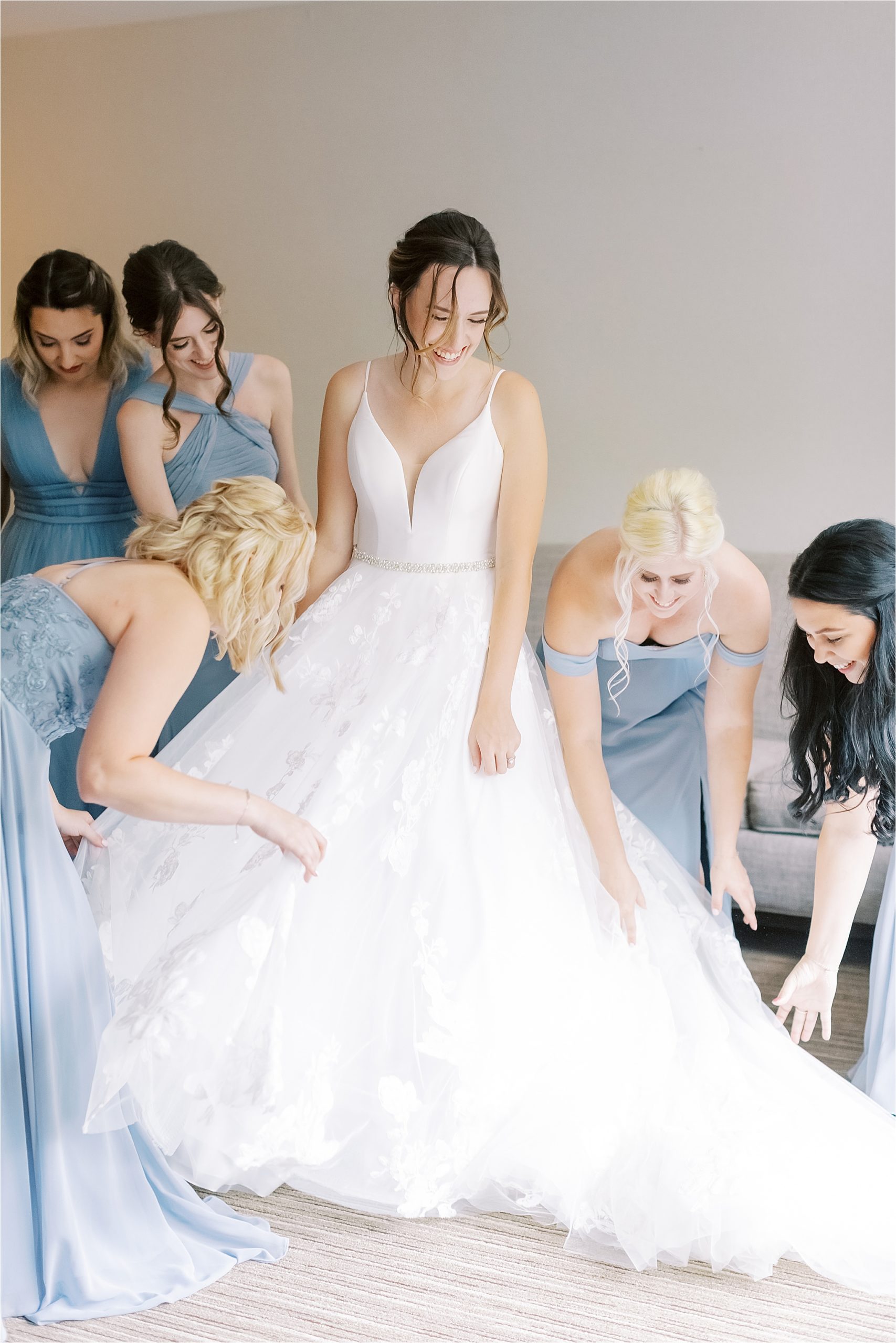 bridesmaids in dusty blue fixing essence of Australia ballgown