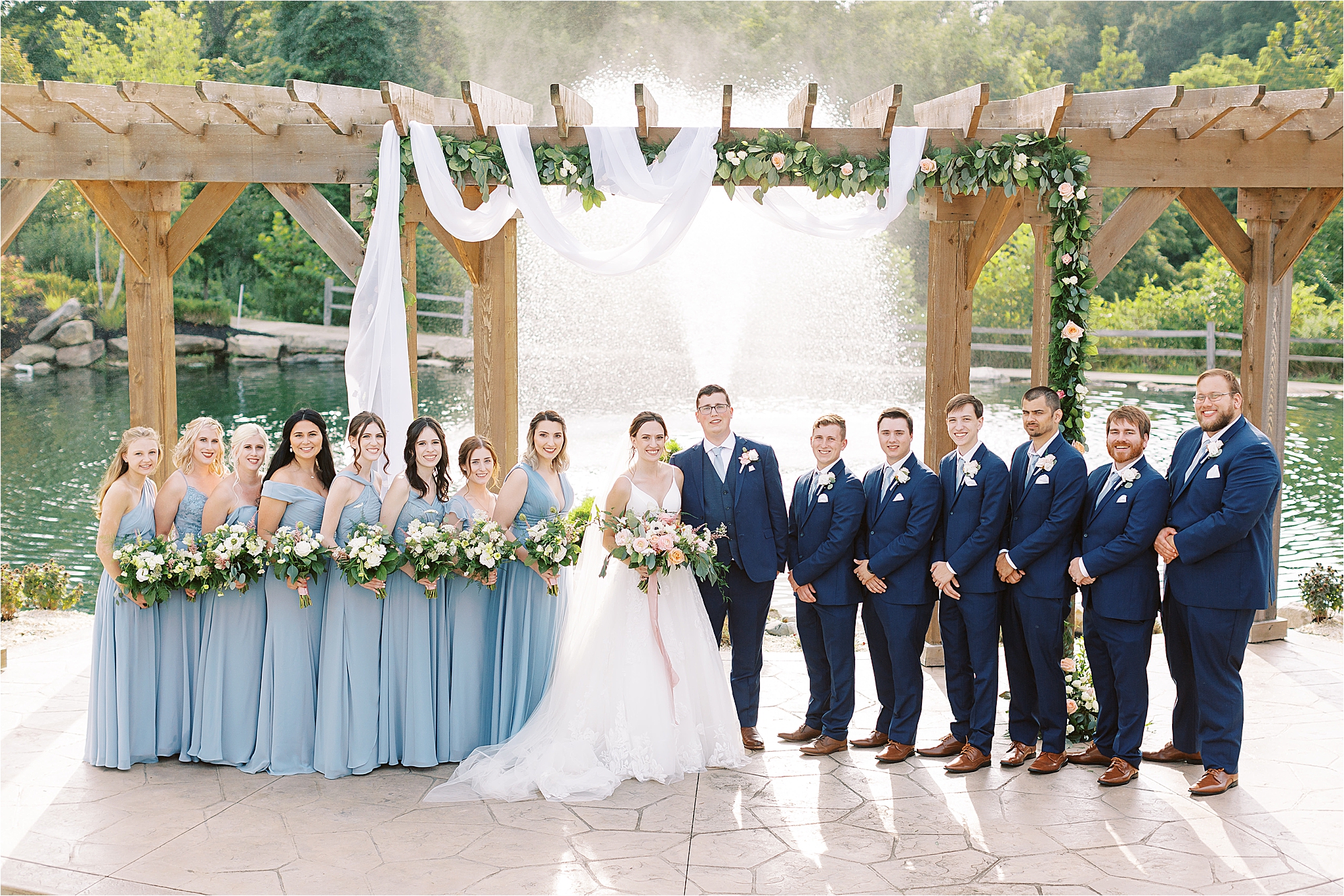 bridal party in front of fountain at Blue Heron Brewery & Event Center Wedding