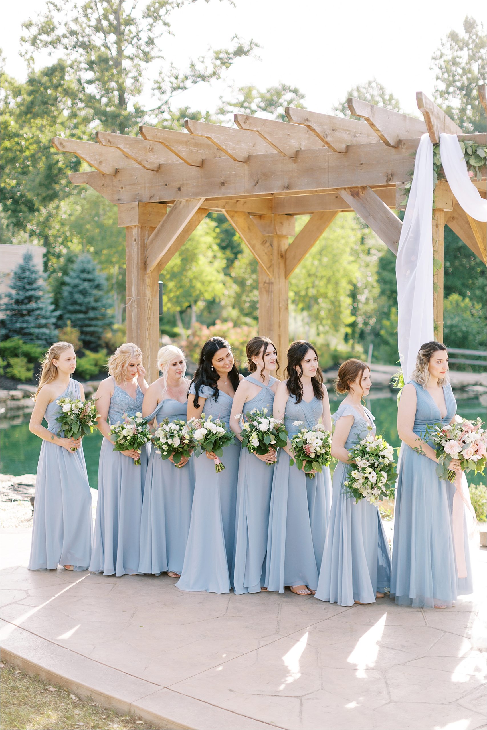 bridesmaids wearing azazie dusty blue gowns