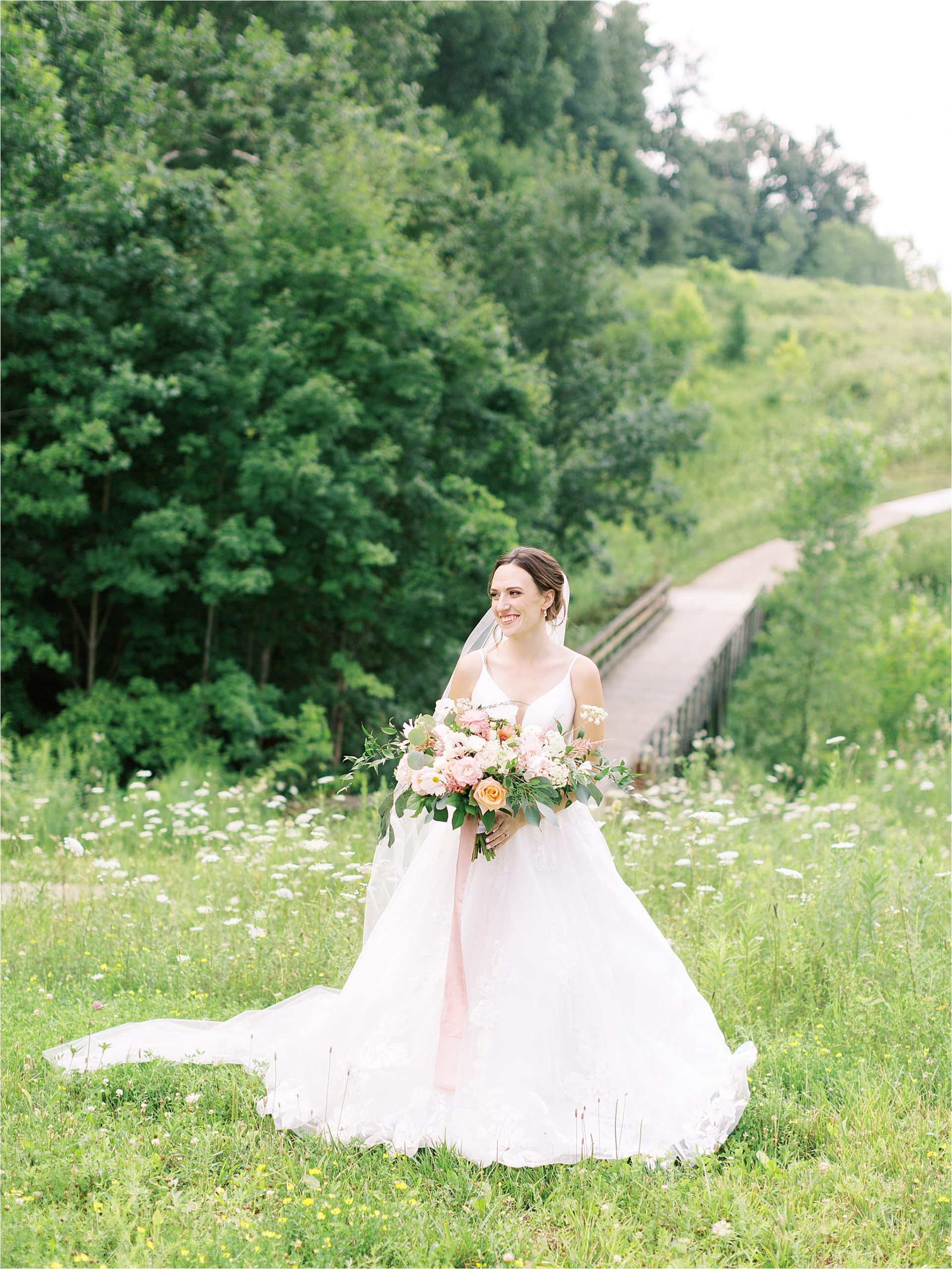 romantic bridal portrait of bride in field at Cleveland Wedding by Austin & Rachel photography