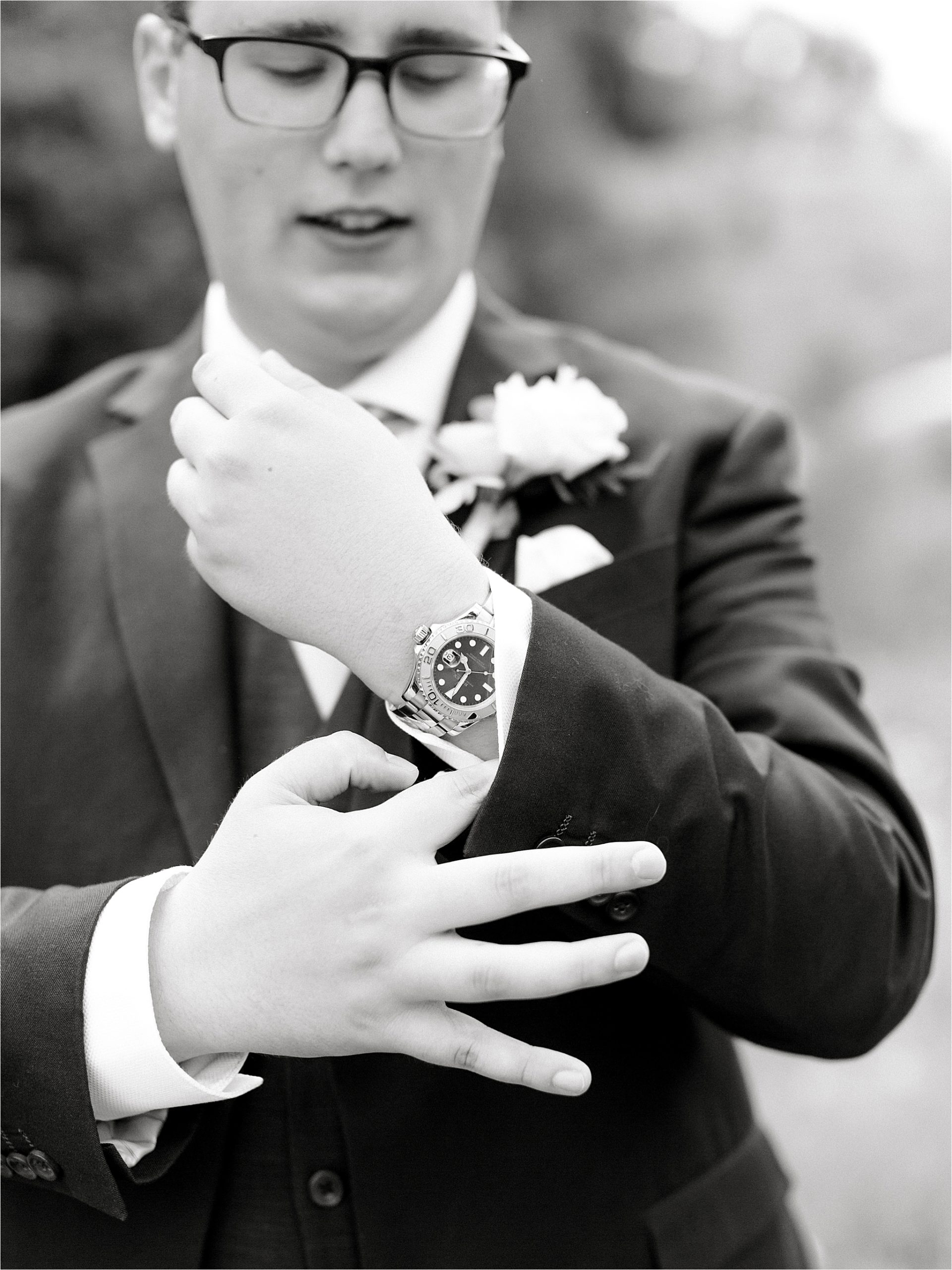 black and white groom portrait of wrist watch 