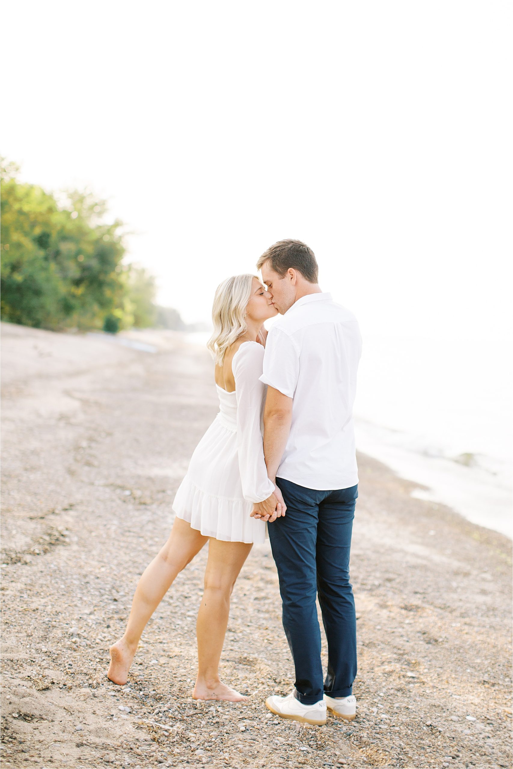 Couple kissing at lake erie engagement session by Cleveland Wedding Photographer