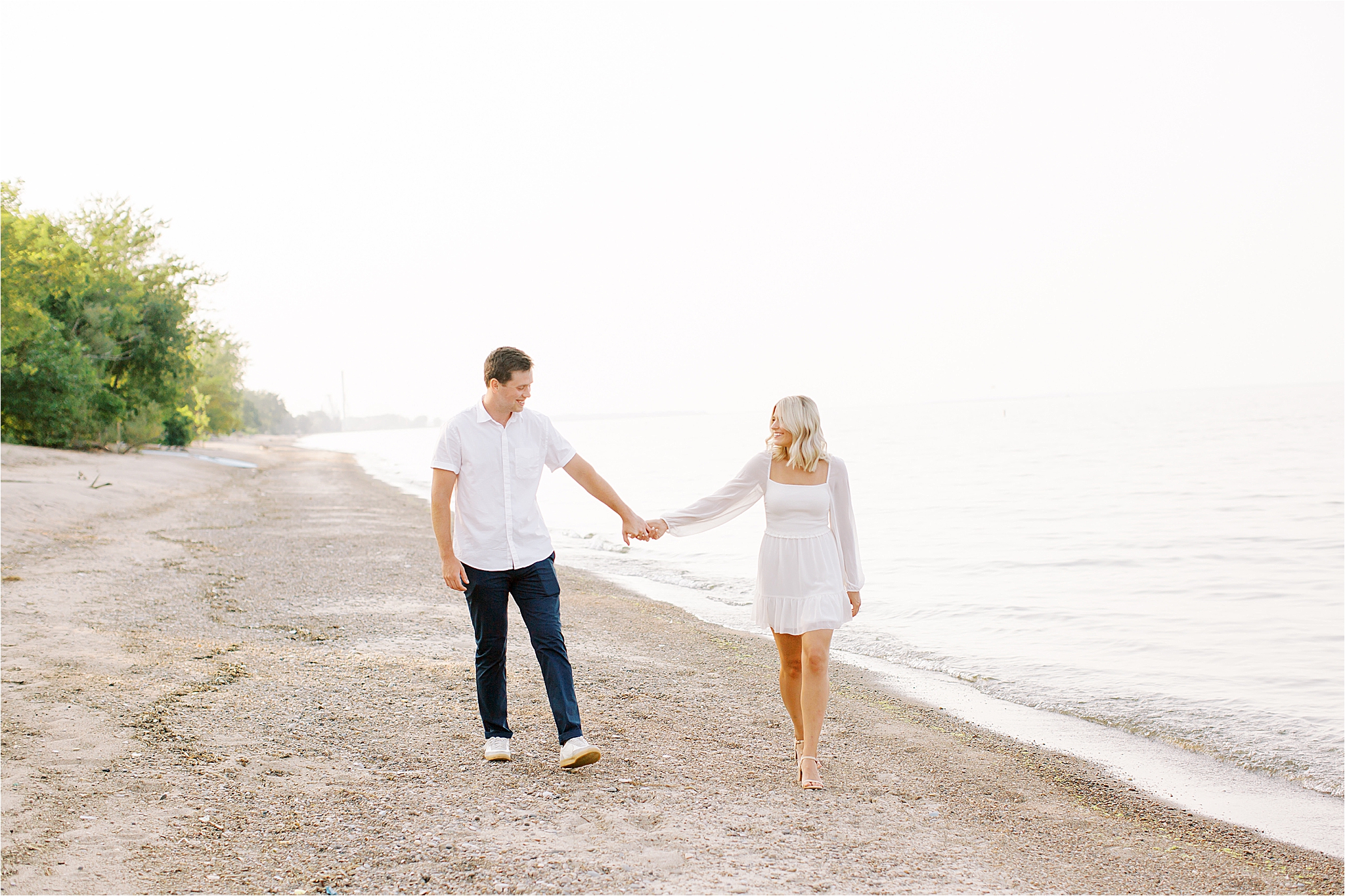 couple walking while on the beach at lake erie