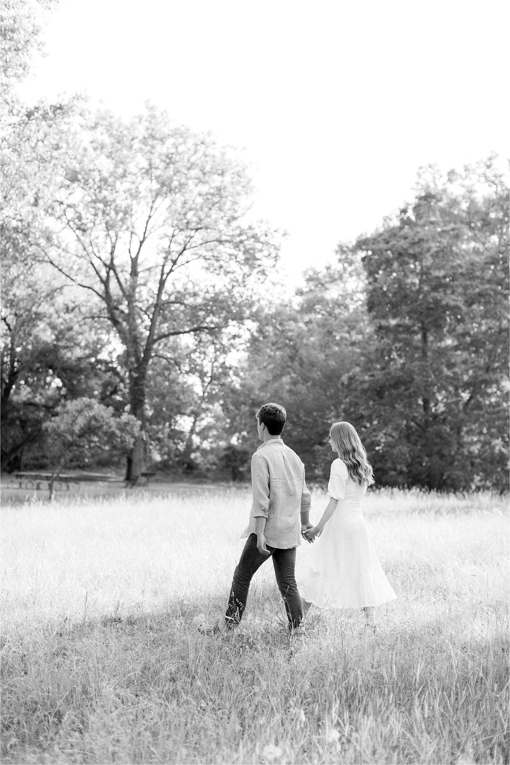 couple walking through field by Cleveland Wedding Photographers
