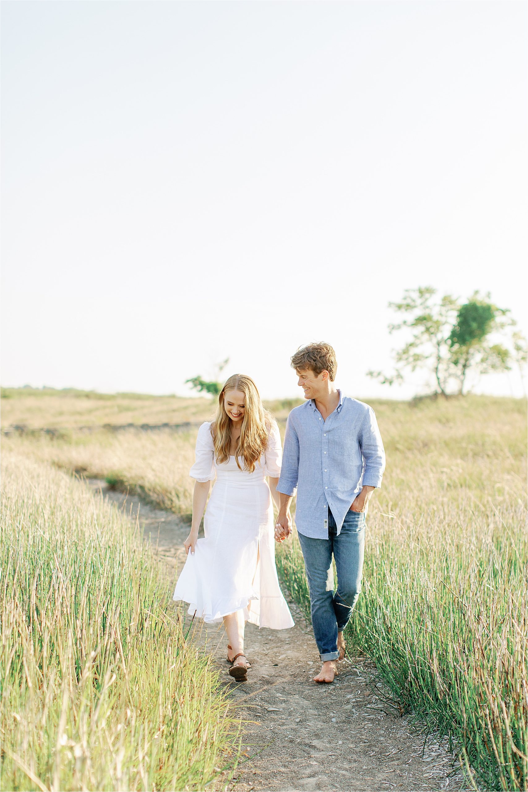 couple walking down beach lane atengagement session by Cleveland wedding photographers