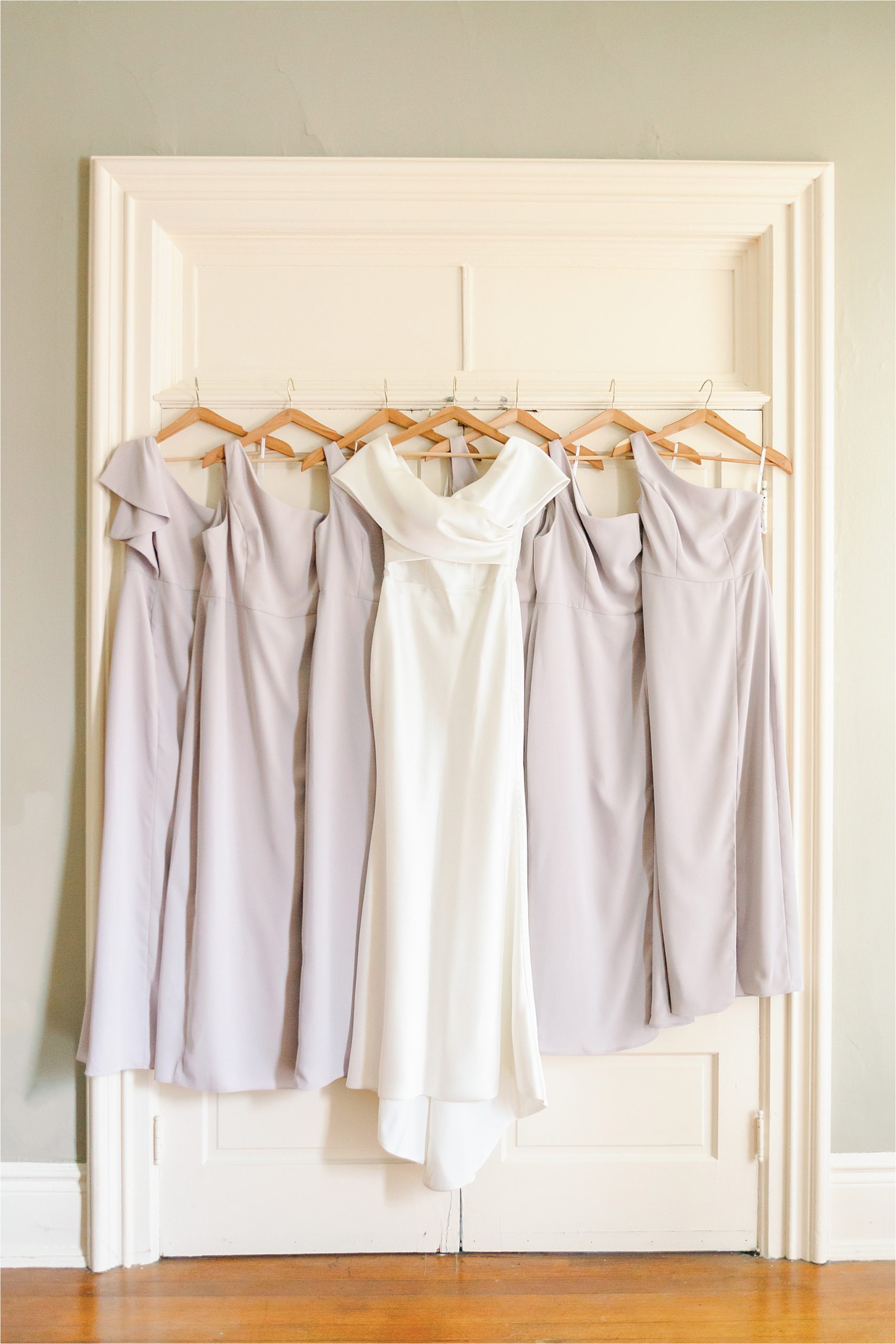 simple bride dress and mauve bridesmaid dresses hanging