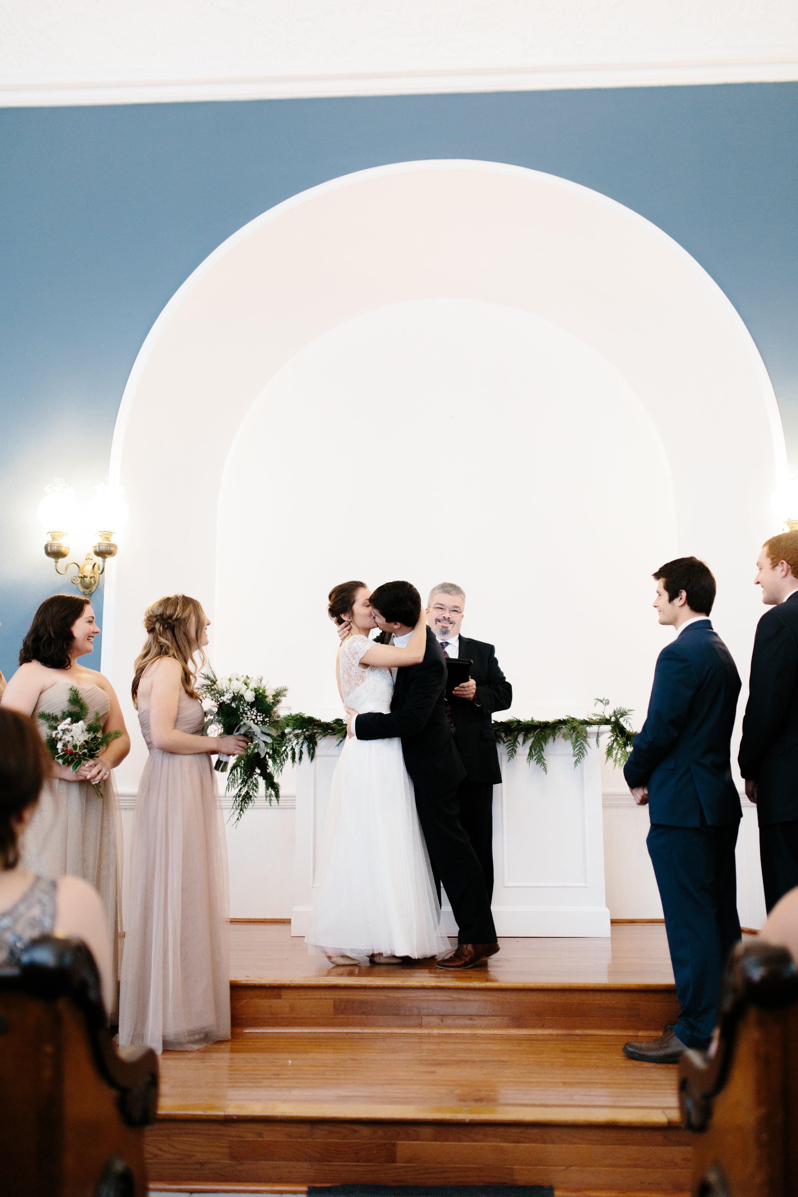 bride and groom kissing in port gamble's st. paul's church