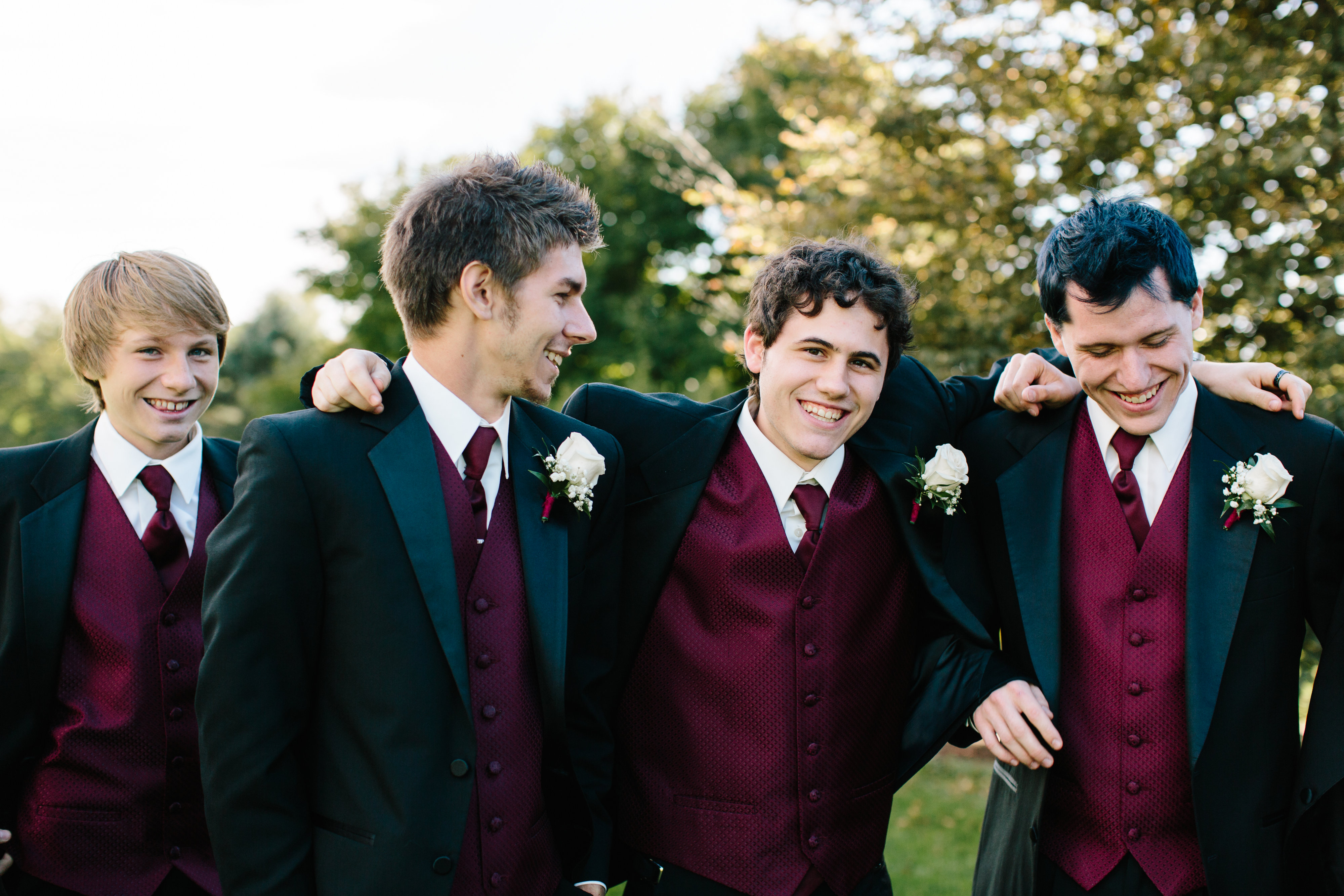 casual groomsmen in maroon vests
