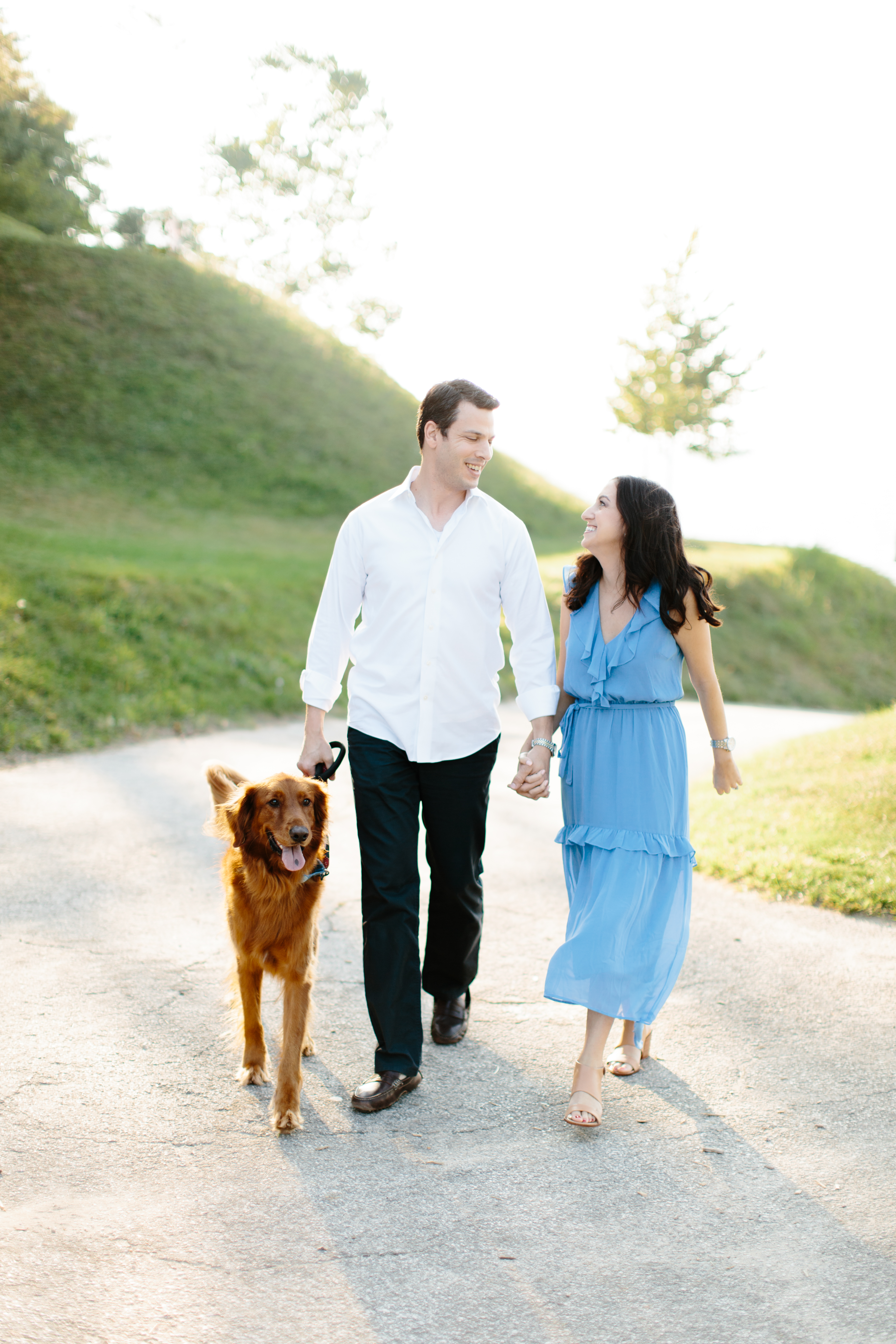 couple walking during engagement session at rocky river